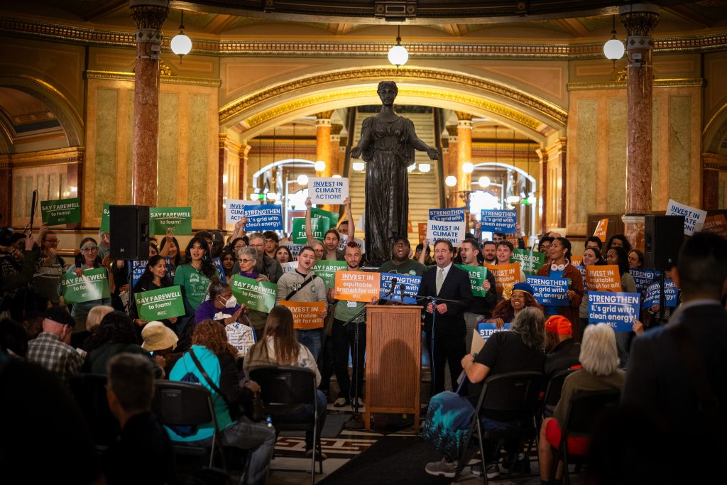 Advocates gather in the Rotunda for a climate action rally.
