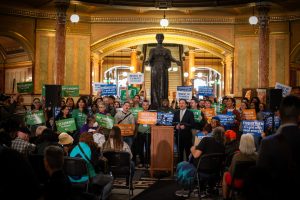 Advocates gather in the Rotunda for a climate action rally.