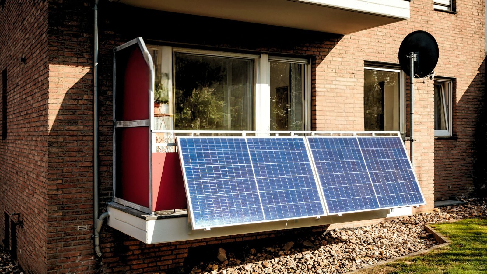 Plug-in solar panel sits on the side of balcony.